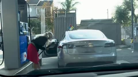 Woman tries to fill Tesla with gas