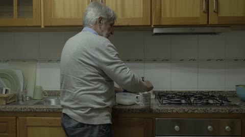 Old man pouring sugar into coffee