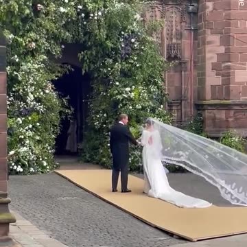 Olivia Henson's dress billows as she arrives at Chester Cathedral