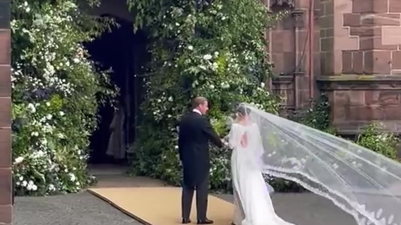 Olivia Henson's dress billows as she arrives at Chester Cathedral