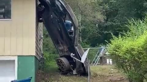 Car hanging on top of roof