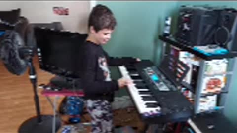 my son eric playing memories on his piano