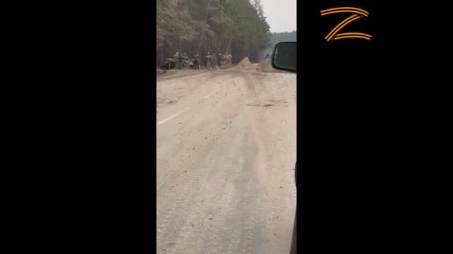 Unaware Ukrainian troops mistake an approaching Russian tank for one of their own