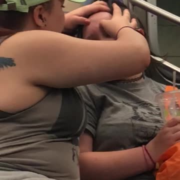 Lady green hat popping guys pimple subway train forehead