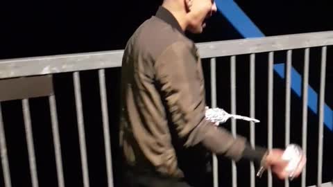 Man on balcony fails to open beer on head