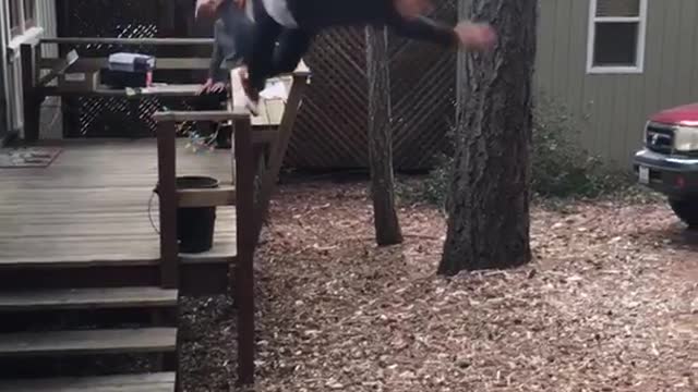 Black sweater tying to do flip falls down