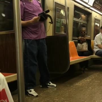 Guy rap battle with himself purple shirt subway reflection