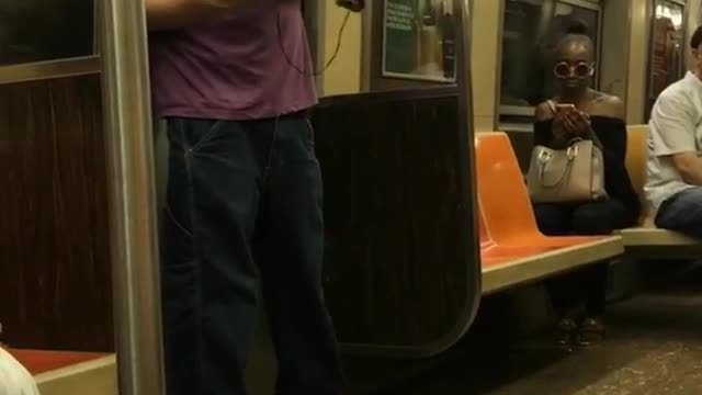 Guy rap battle with himself purple shirt subway reflection