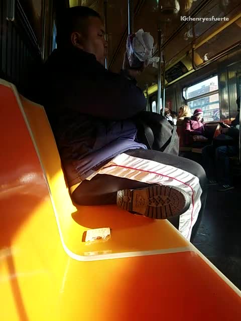 Guy eats pop tart food out of subway seat
