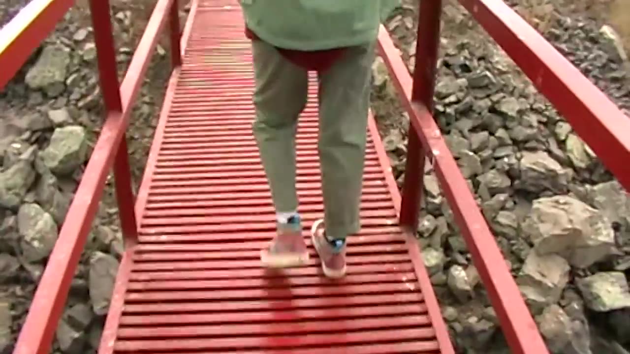 Woman walking over an iron pile