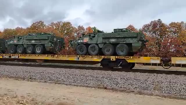 TRAIN LOADED WITH MILITARY VEHICLE .