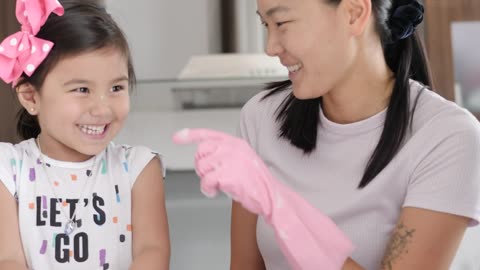 Happy mother and daughter cleaning their house
