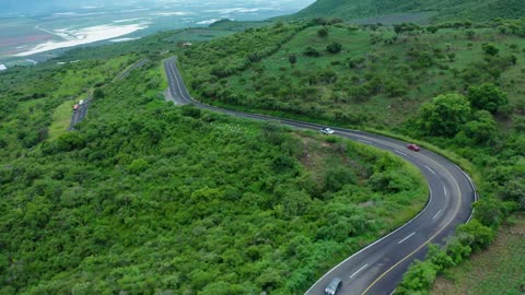 Curvy road on a tree covered hill