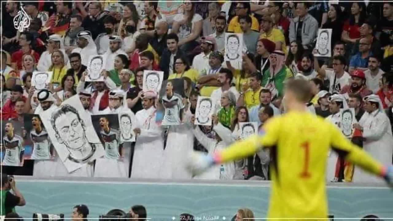 Fans in Qatar held up photos of Mesut Ozil and covered their mouths during Germany vs Spain