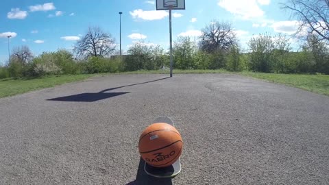 Guy Lands a Basket Hitting Skateboard With Ball on It While Driving a Bicycle