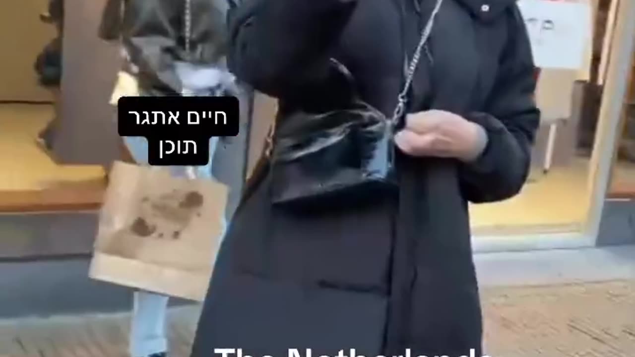 Young Nazi Islamist woman in Amsterdam, Netherlands destroys posters of Israeli civilians