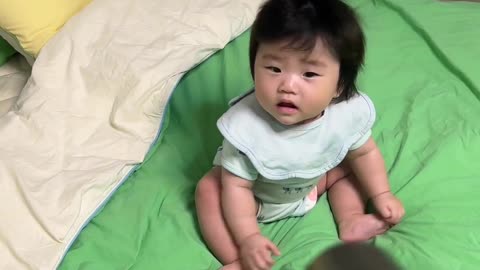 Cute asian baby with blow dryer