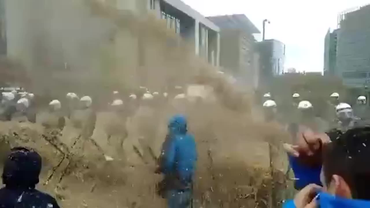 Dutch farmers are spraying government buildings and riot police with MANURE!