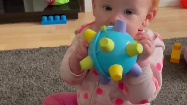 Child loving making silly noises with her toy! Shows Red Head temper when it stops!!