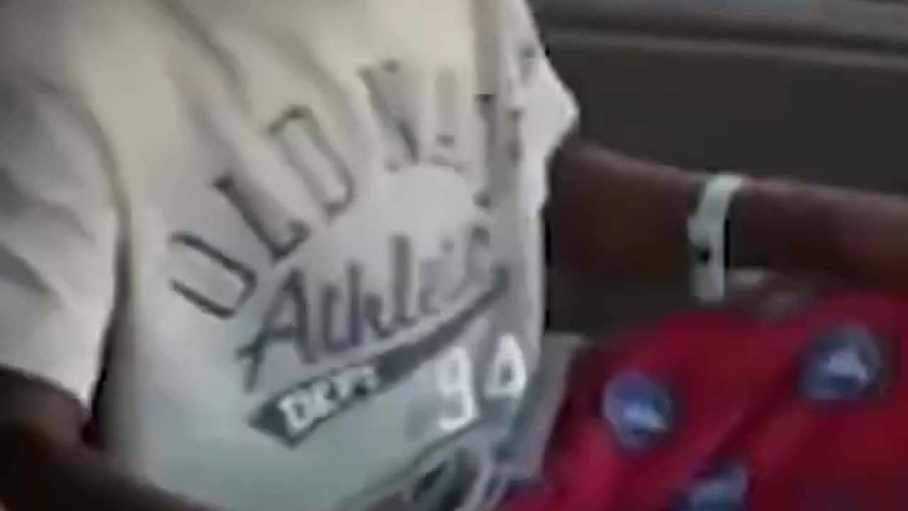 Black funny kid laughing in car