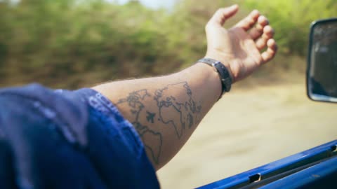 Man Driving With Hand Outside The Vehicle