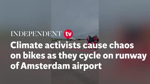 Climate activists ride bikes on runway of Amsterdam airport and block private jets from taking off