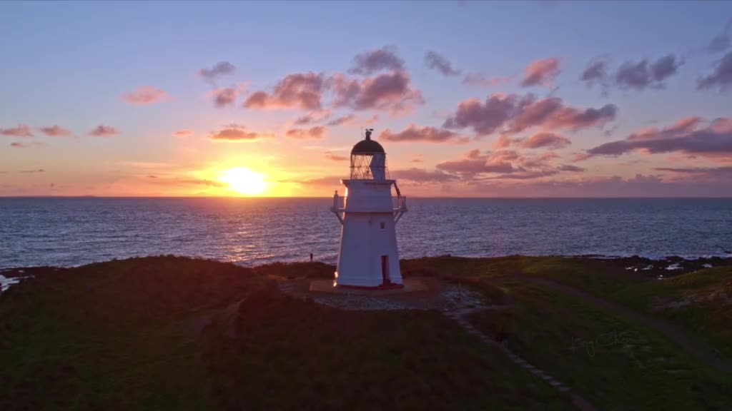 New Zealand's clouds, stars and favorite lighthouse at sunset.