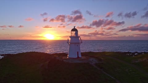 New Zealand's clouds, stars and favorite lighthouse at sunset.