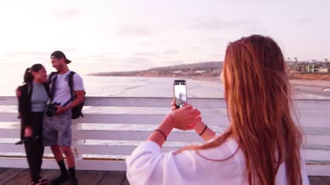 Woman Takes Picture of Friends on Vacation