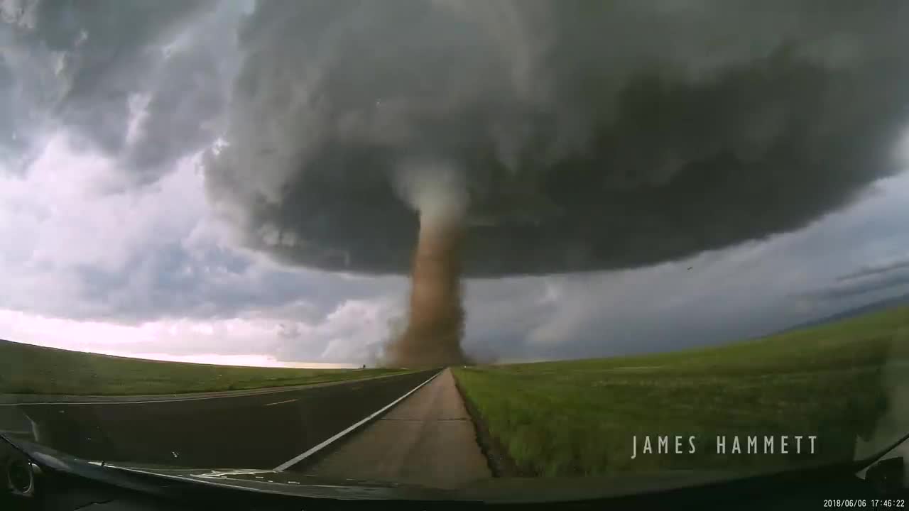 Storm chasing dashcam: Tornado crossing the highway! Laramie, Wyoming