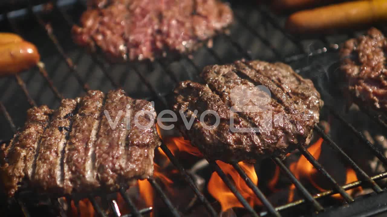 Mixed American barbecue food on hot grill