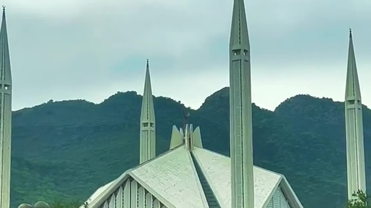 "Harmony in Stone and Nature: Faisal Mosque Framed by Breathtaking Hills"