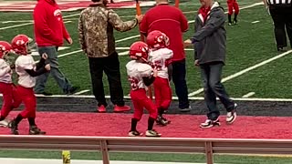 Peewee Football Player Grooves Away on the Sidelines