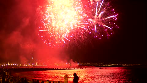 Fireworks illuminating the beach sky