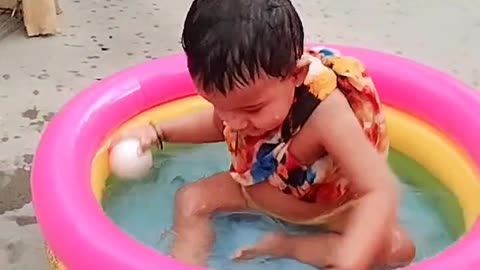 baby girl enjoy bath in bath tub