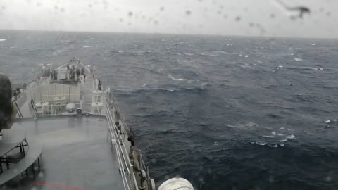 War ship infront of the huge cyclone