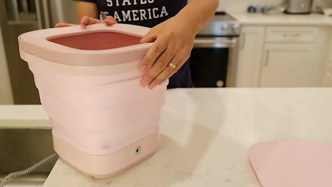 Close-up of a woman with a laundry basket washing clothes