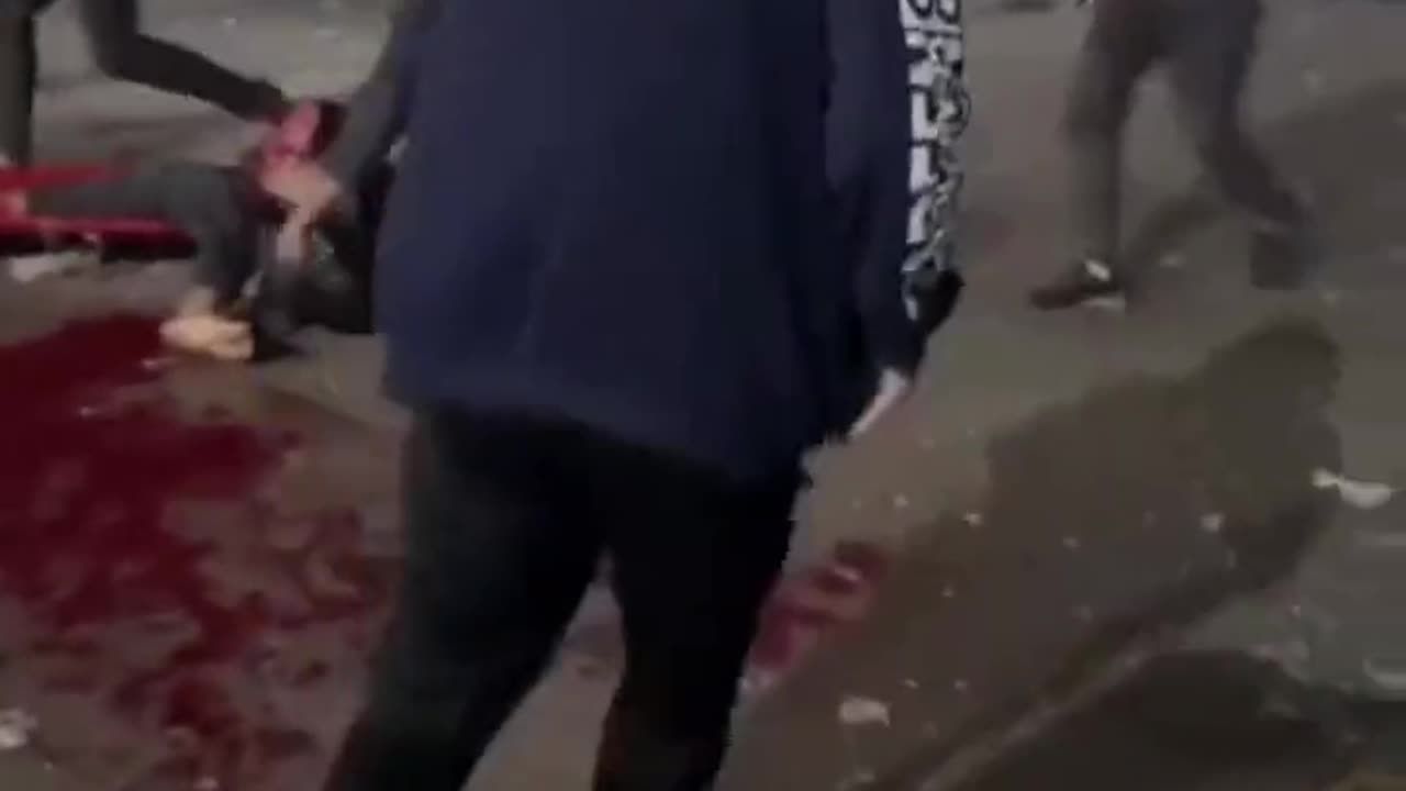 An Hamas shell lands in a hospital parking lot filled with people due to the hospital being overrun.