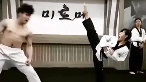 A man at a taekwondo gym kicked a cup away with his foot