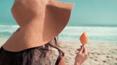 Girl eating ice cream at beach