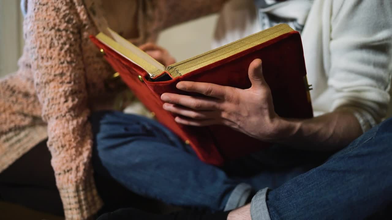 Couple sitting watching a photo album