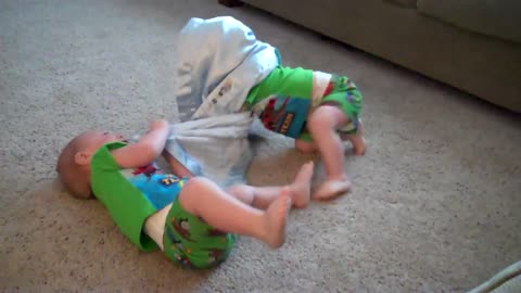 Twin age playing with their Boston Terrier.