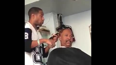 Smoky man cuts a man's hair