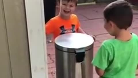 Kids Jokingly Hit Each Other With Trash Can's Lid by Stepping on It's Pedal