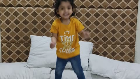 Fatima jumping on bed