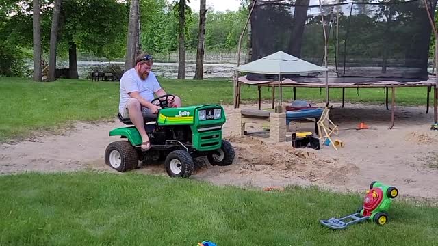 Husband Goofing off on Lawnmower Ends up Dragging Behind it