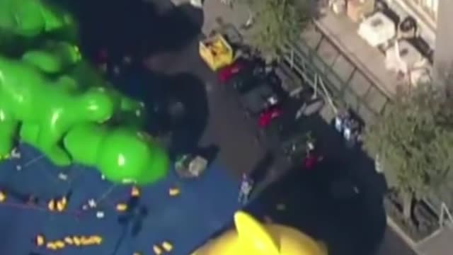 Spectators watch the inflation of balloons for the annual Macy's Thanksgiving Day Parade