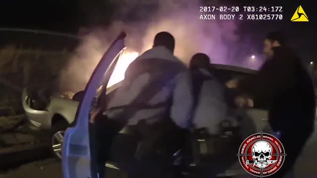 Policemen Saving Driver from Car on Fire.