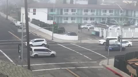 Crazy man is attempting to stop traffic while nearly getting hit