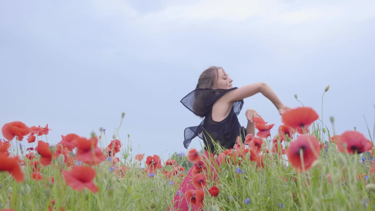 Girl dancing happily in a field of flowers